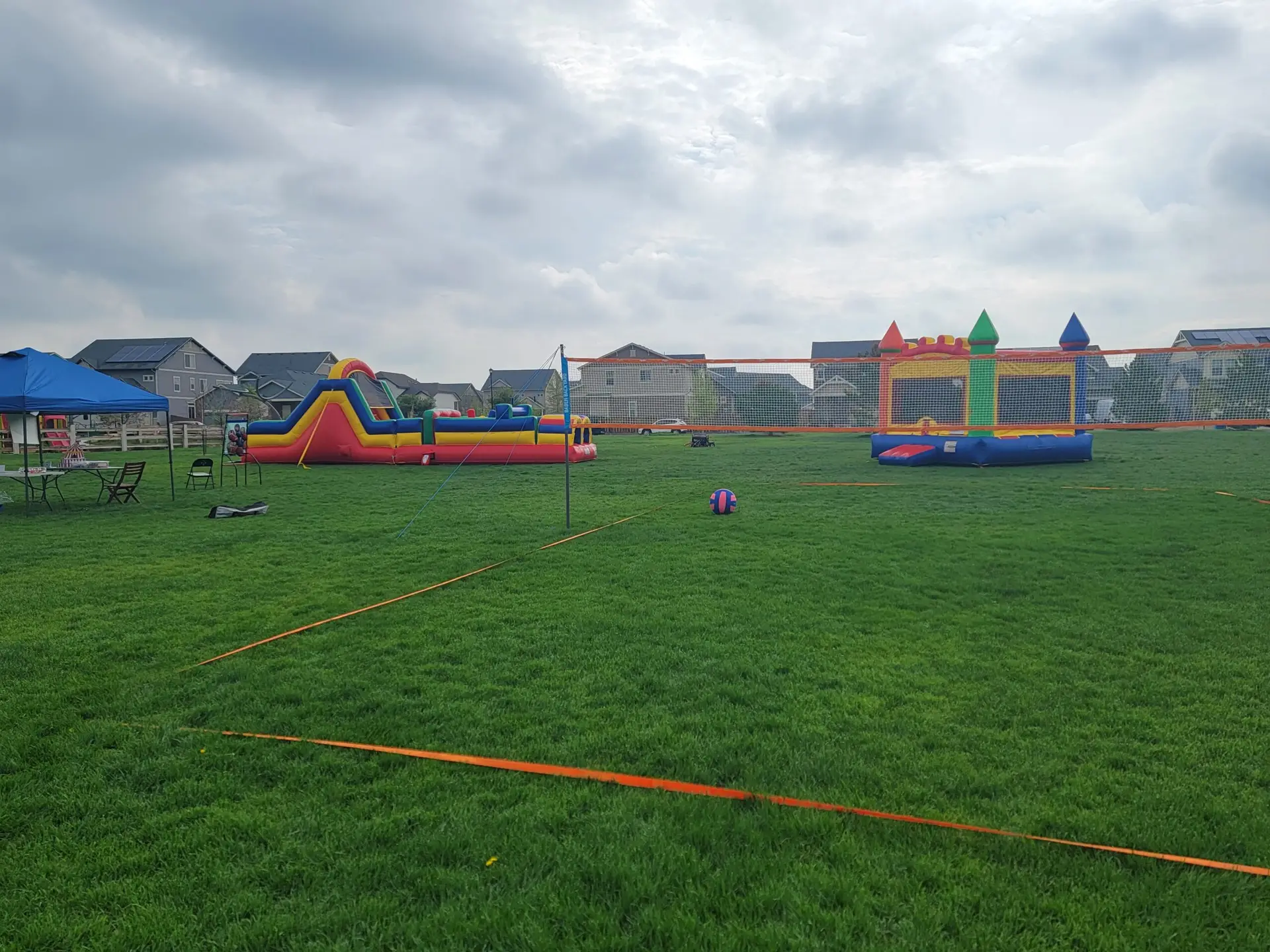 Bounce N Around obstacle course, volleyball game, and inflatable setup for a Colorado community event