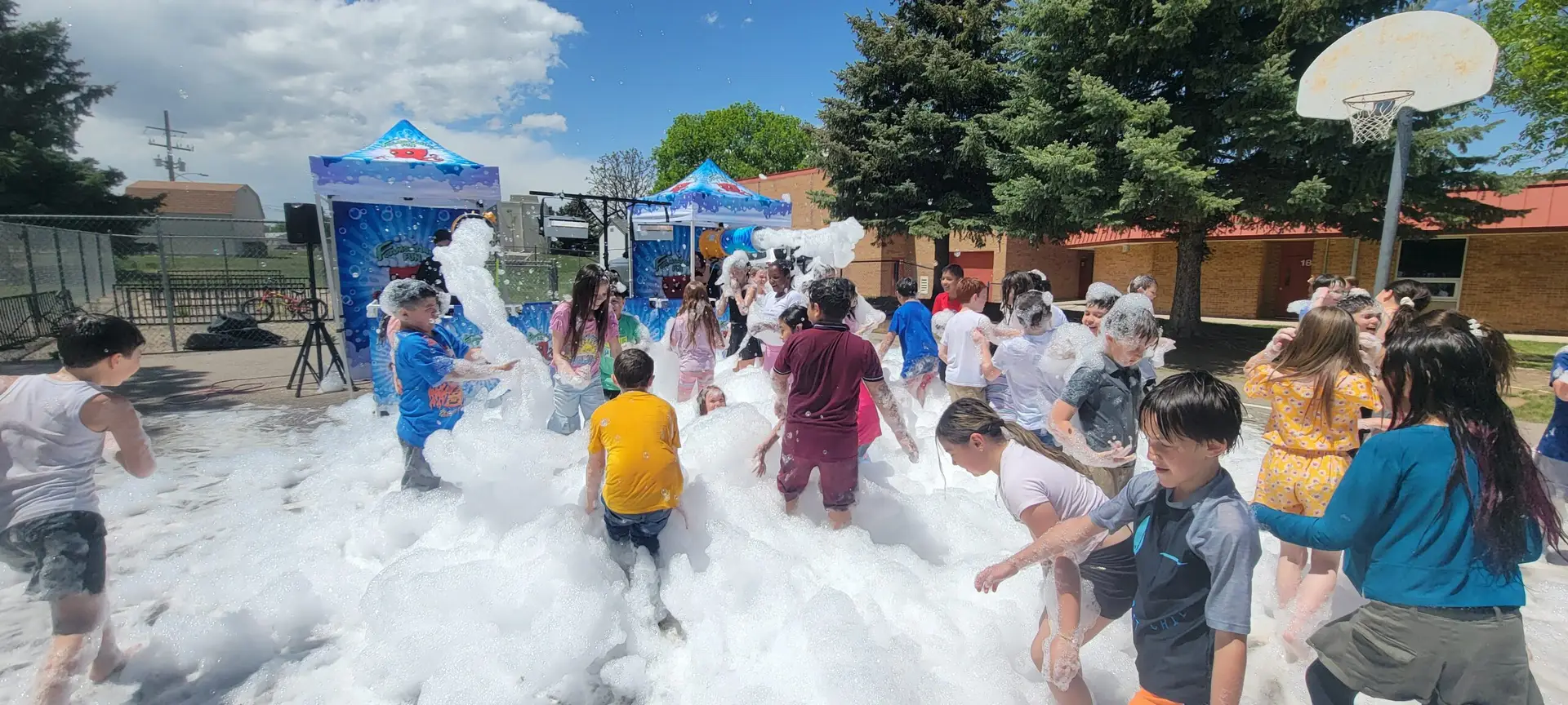 Students enjoying a large Foamsational Fun foam party at a Colorado school